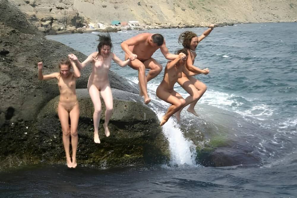 Mens and girls nudists on a beach - The benefits of naturist vacations