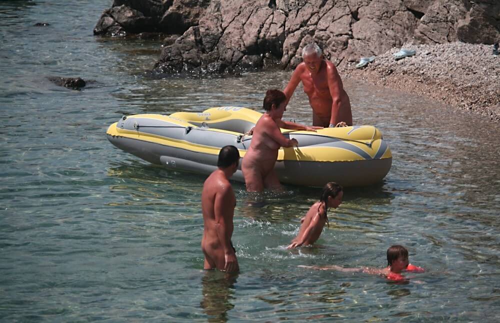 Lone Nudist in Yellow Boat photos - Nudism and naturism are a path to accepting ones own nature